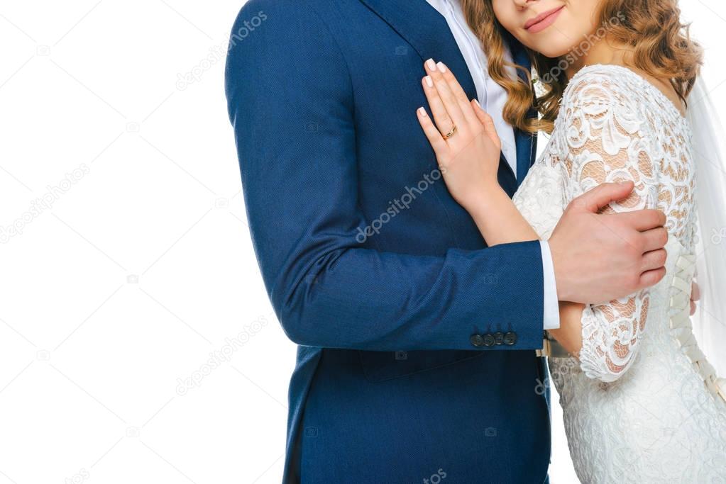 partial view of wedding couple hugging each other isolated on white