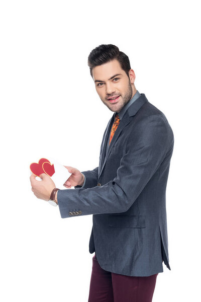 handsome man with valentines greeting card, isolated on white