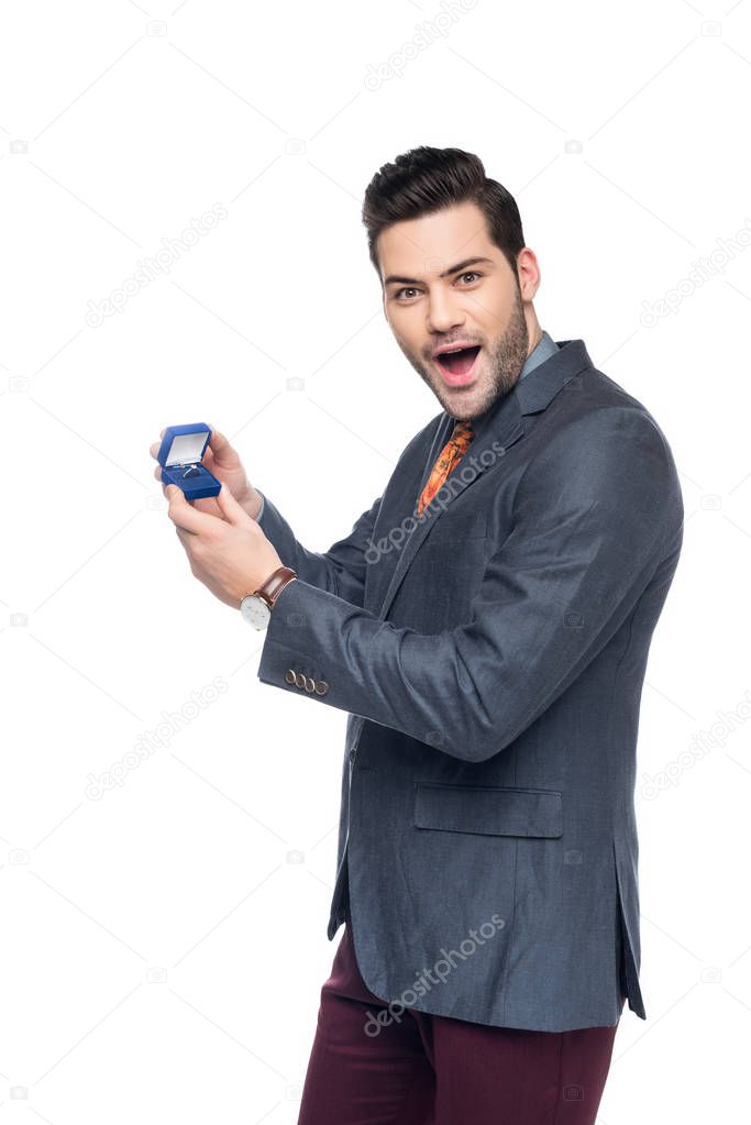 excited man holding box with proposal ring, isolated on white