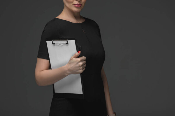 cropped shot of kazakh businesswoman holding clipboard isolated on grey