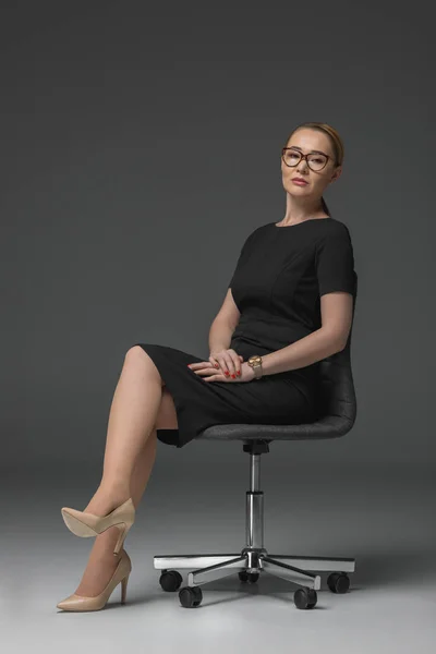 Beautiful Kazakh Woman Eyeglasses Sitting Chair Looking Camera Grey — Stock Photo, Image