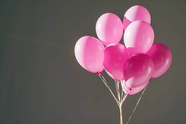 pink balloons for party, isolated on grey