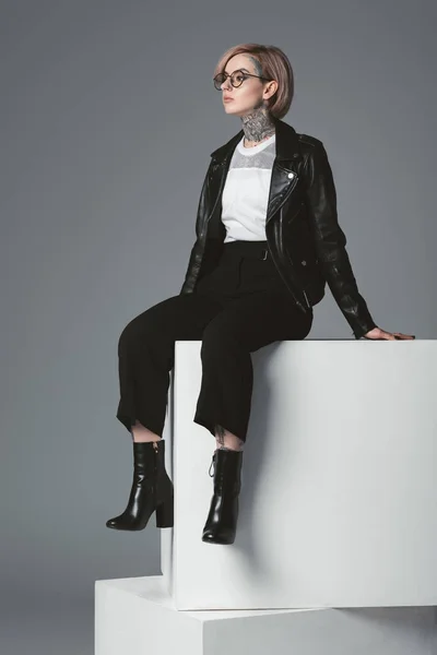 Beautiful Young Tattooed Woman Leather Jacket Sitting White Cubes Looking — Stock Photo, Image