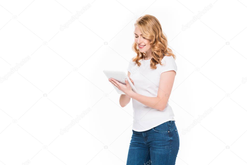 portrait of smiling woman using digital tablet isolated on white