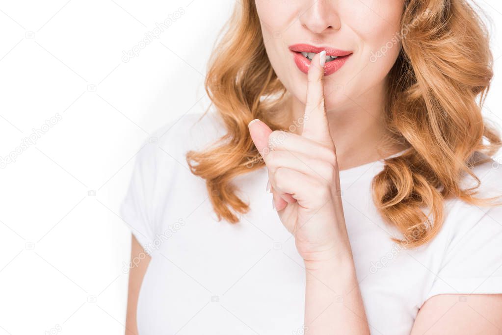cropped shot of woman showing silence sign isolated on white