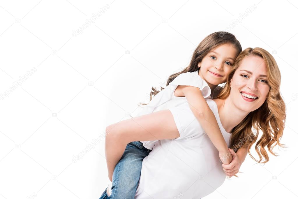 happy mother and daughter piggybacking together isolated on white