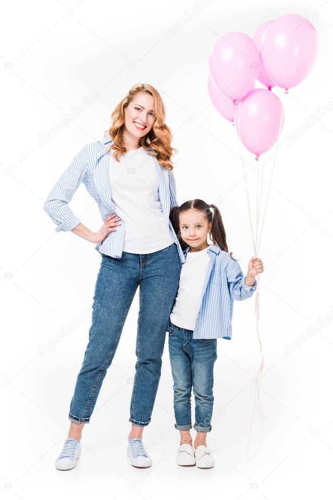 smiling mother and daughter with pink balloons isolated on white