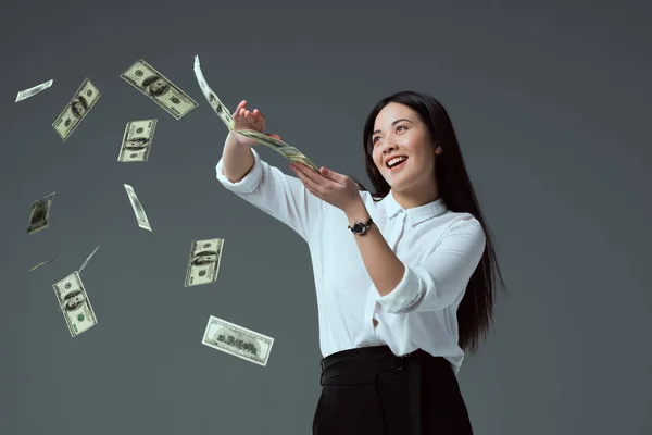 Smiling Asian Girl Throwing Dollar Banknotes Isolated Grey — Stock Photo, Image