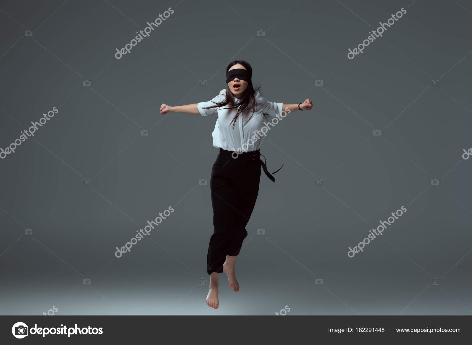 Young Woman Wearing Black Blindfold Isolated On Grey Stock Photo