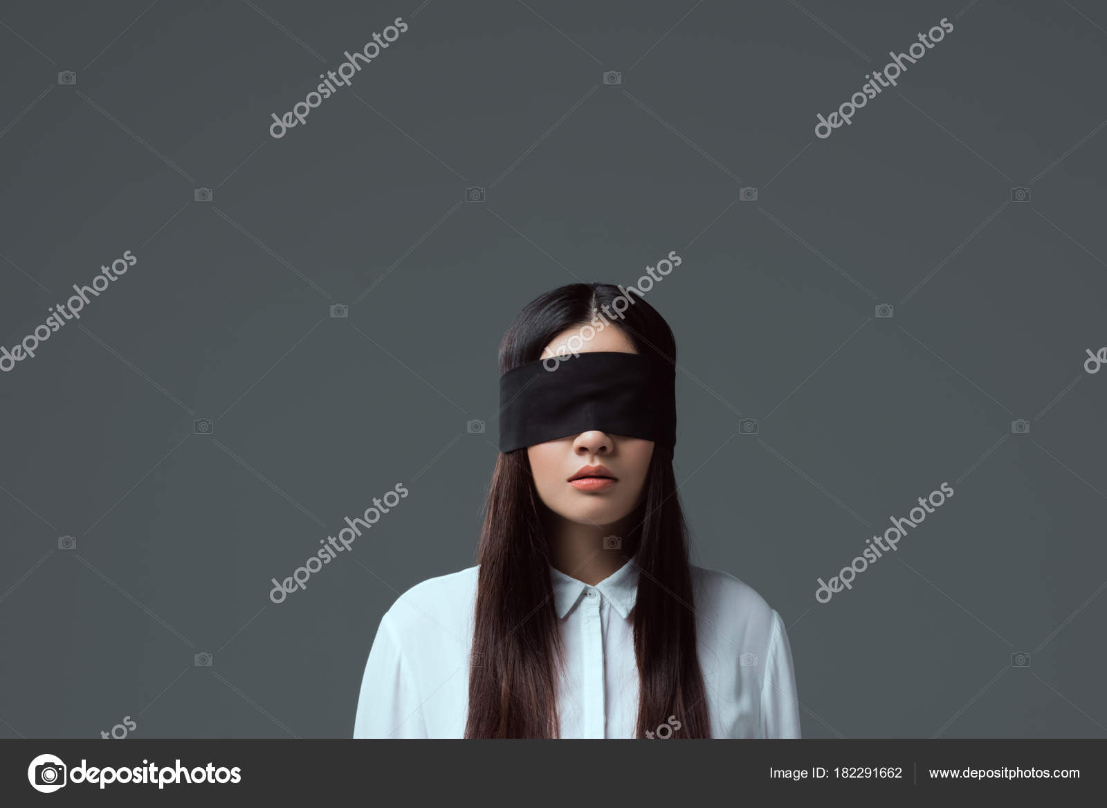 Young Woman Wearing Black Blindfold Isolated On Grey Stock Photo