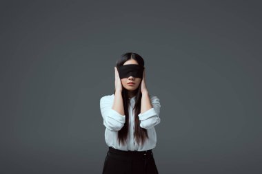 young blindfolded woman closing ears isolated on grey  clipart