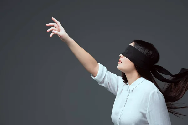 Side View Young Woman Wearing Black Blindfold Raising Hand Isolated — Stock Photo, Image