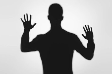 mysterious blurry shadow of person raising hands on grey clipart