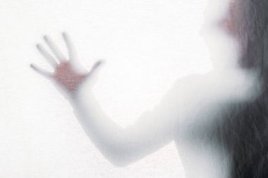 blurry silhouette of screaming person touching frosted glass clipart