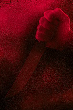 cropped shot of human hand holding knife in red light with glitches  clipart