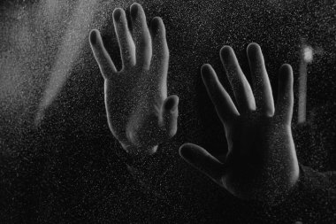 cropped shot of person touching frosted glass with palms in darkness   clipart