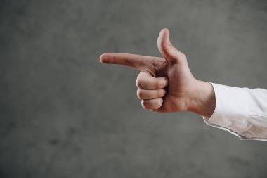 close-up partial view of man pointing away with finger on grey clipart