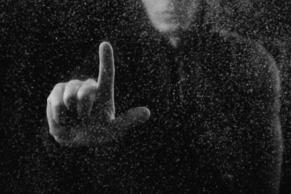 cropped shot of person touching frosted glass with finger