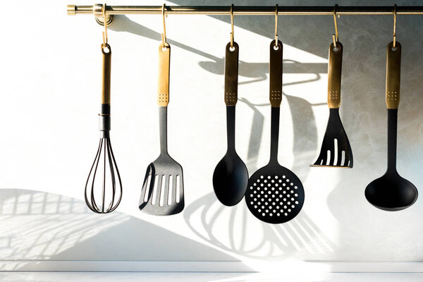 close-up view of various utensils hanging in kitchen 