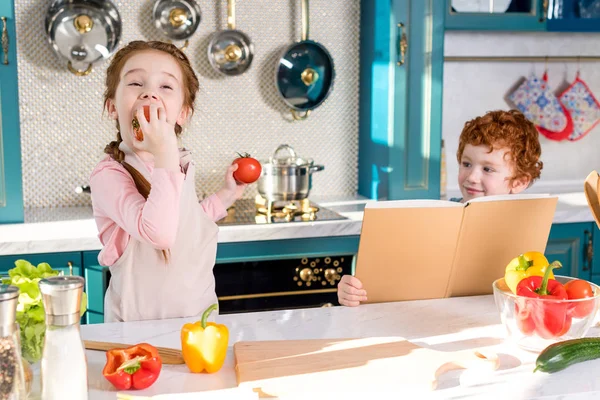 Little Boy Holding Cookbook While Adorable Child Eating Tomato Kitchen — Stock Photo, Image