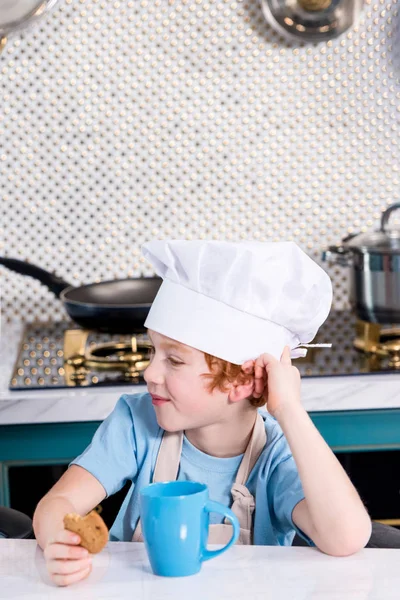 Cute Little Boy Chef Hat Drinking Tea Eating Cookie Kitchen — Free Stock Photo