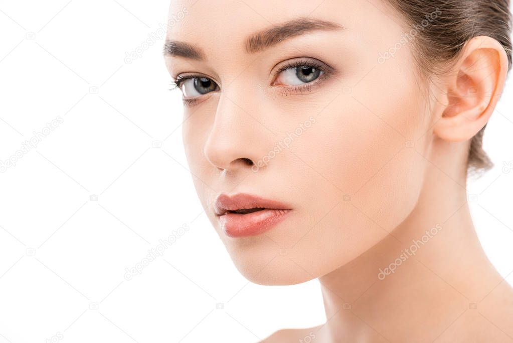 young woman with clean skin looking at camera, isolated on white