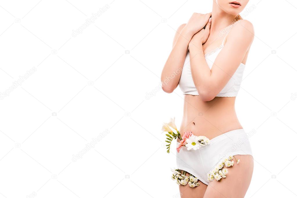 cropped view of girl with flowers in panties, isolated on white, intimate care concept