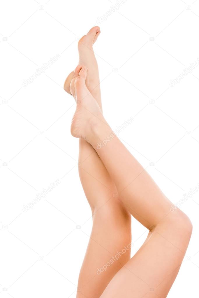 cropped view of beautiful female legs, isolated on white