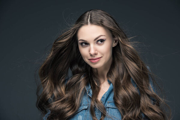 portrait of pretty girl with long hair, isolated on grey