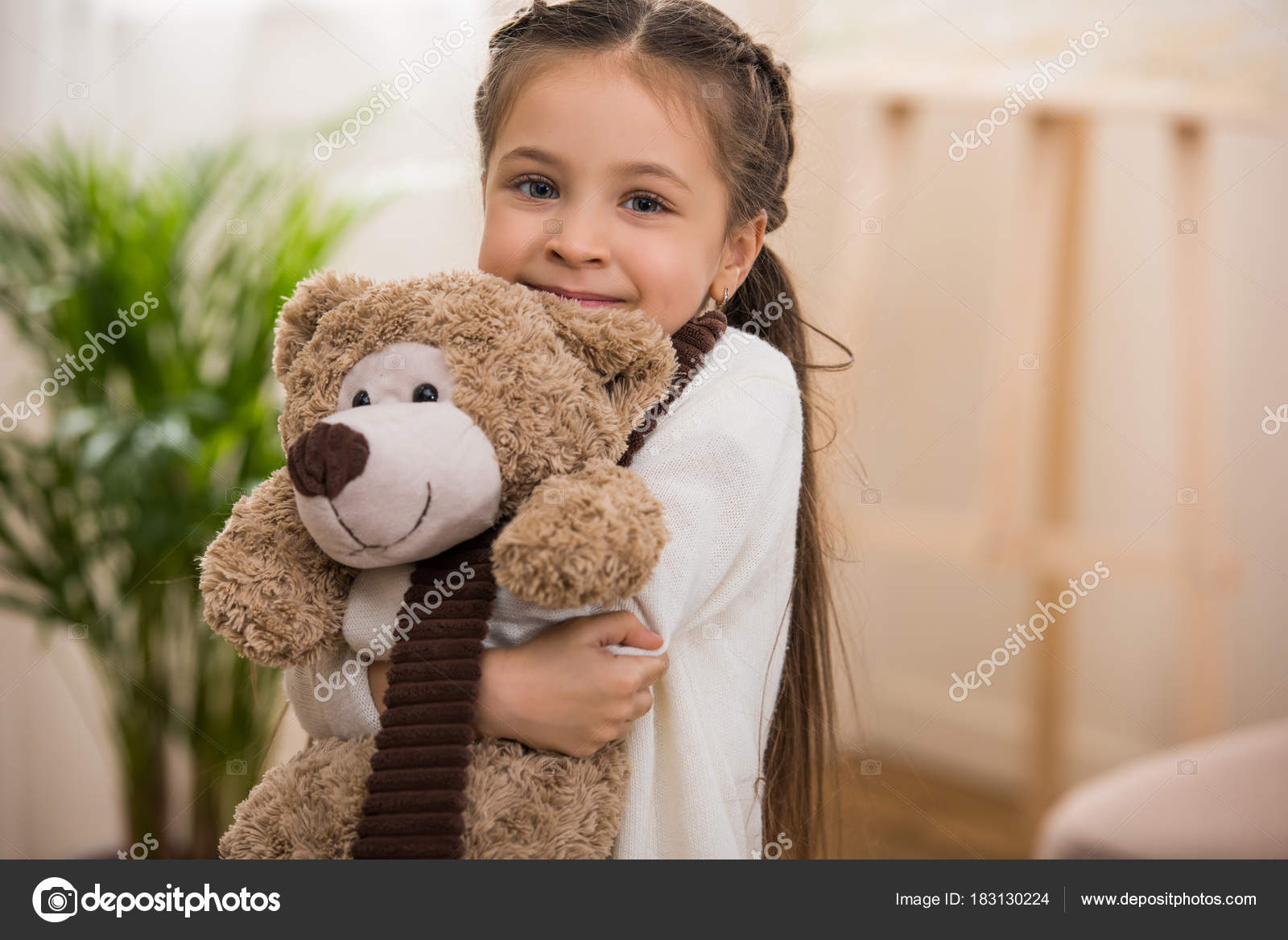 kid hugging teddy bear