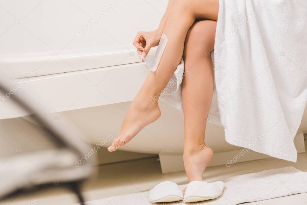 partial view of woman doing wax depilation at home
