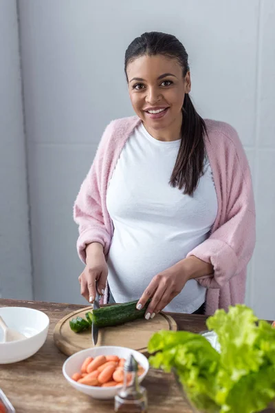 African American Pregnant Woman Cutting Cucumber Salad Kitchen — Stock Photo, Image