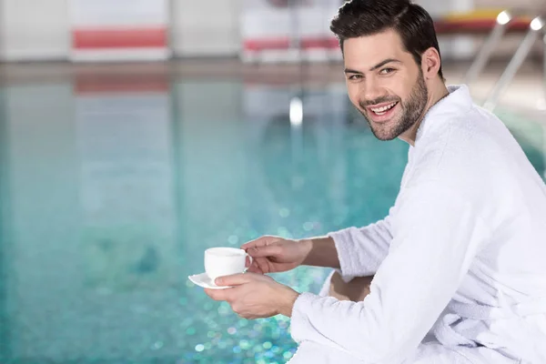 Handsome Young Man Bathrobe Holding Cup Coffee Smiling Camera Spa — Stock Photo, Image