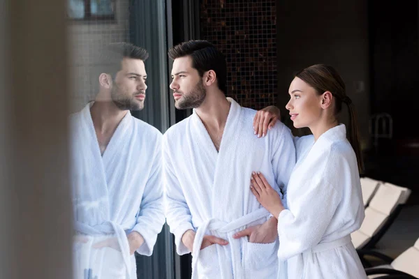 Young Couple Bathrobes Standing Together Looking Away Spa Center — Stock Photo, Image
