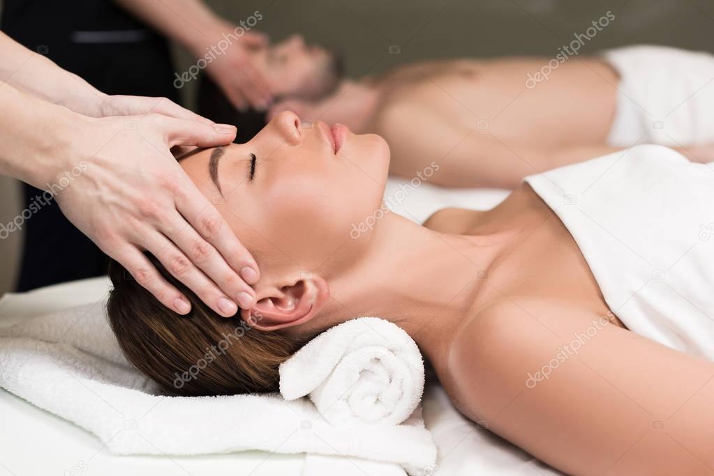 close-up partial view of young couple having massage in spa salon  