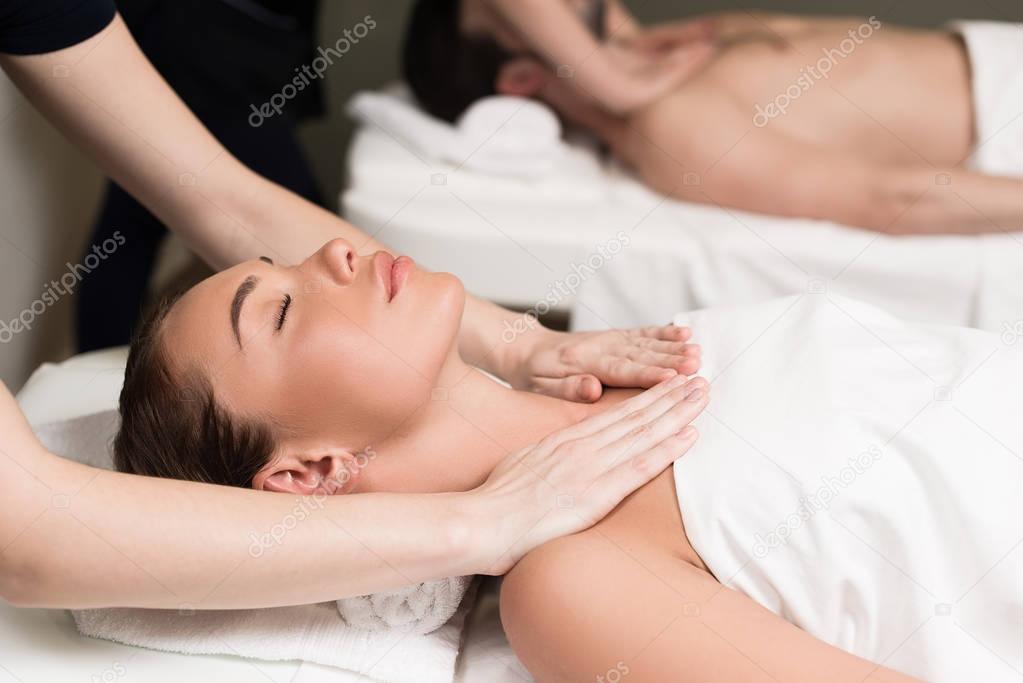 selective focus of couple having massage in spa salon