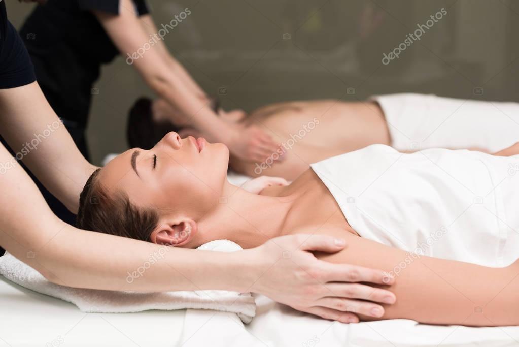 side view of couple having massage in spa salon 