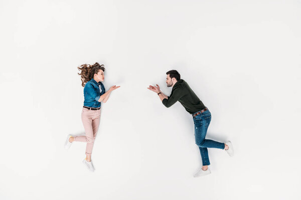 top view of woman throwing blown kiss to boyfriend isolated on white