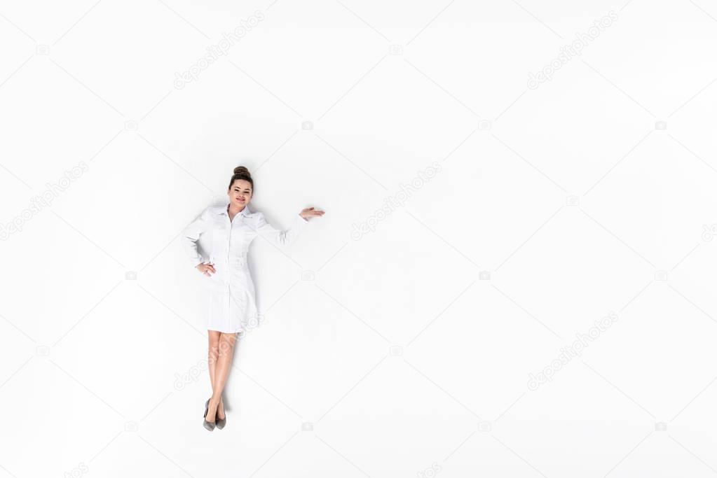 top view of young female doctor isolated on white