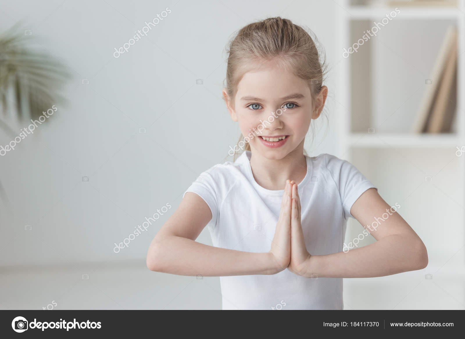 Smiling Little Child Practicing Yoga Making Namaste Gesture Stock Photo by  ©AllaSerebrina 184117370