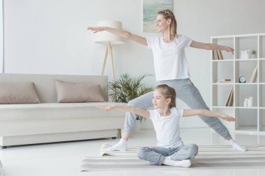 Anne ve kızı pratik yoga birlikte