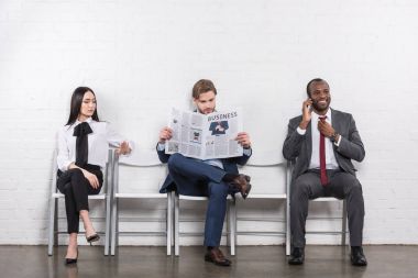 multicultural business people waiting for job interview clipart