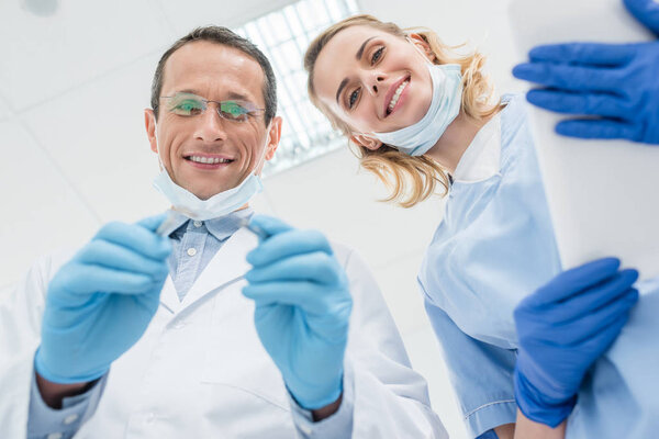 Стоматологи проверяют зубы пациентов в современной клинике
