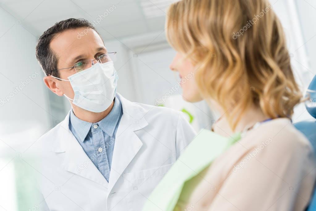 Woman consulting with doctor in modern dental clinic