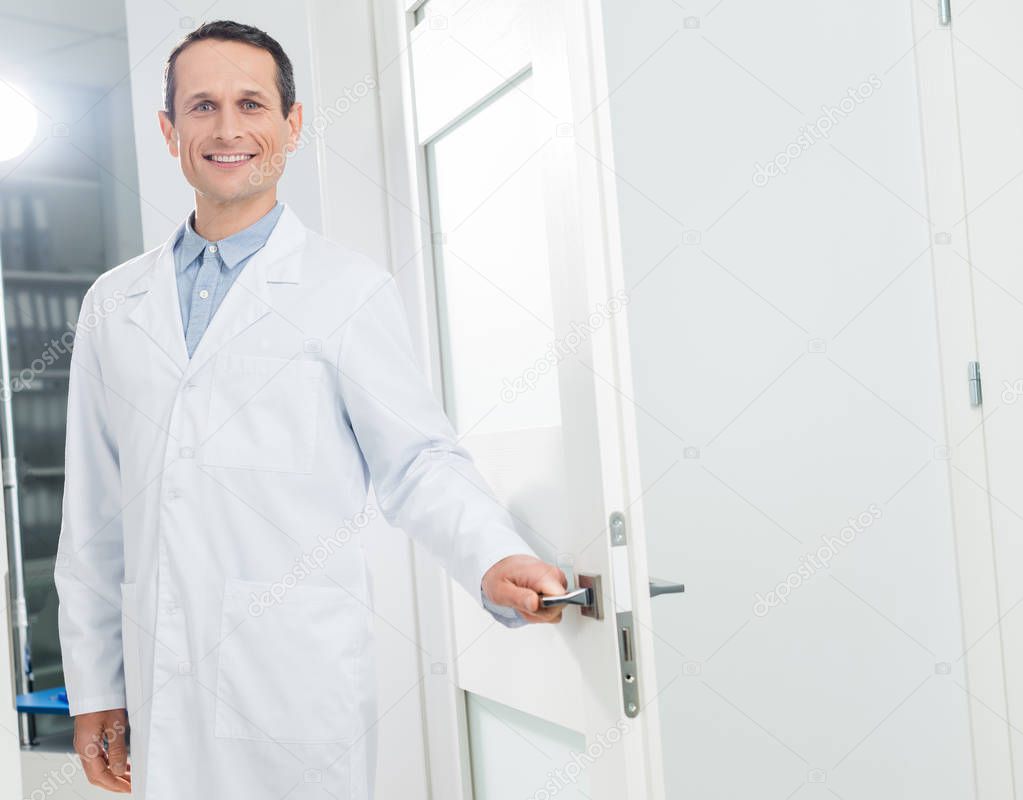 Doctor welcoming patient in modern clinic