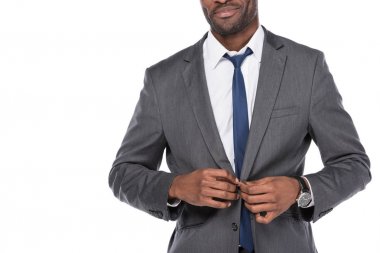 cropped shot of african american businessman buttoning suit isolated on white clipart