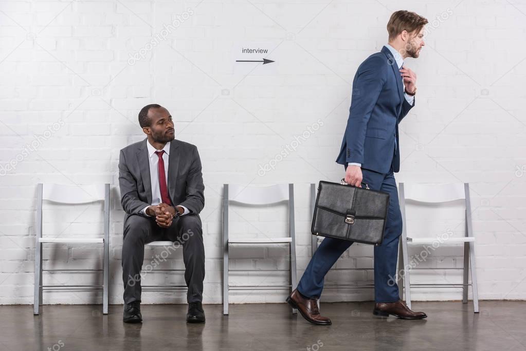 african american businessman looking at caucasian colleague going on job interview