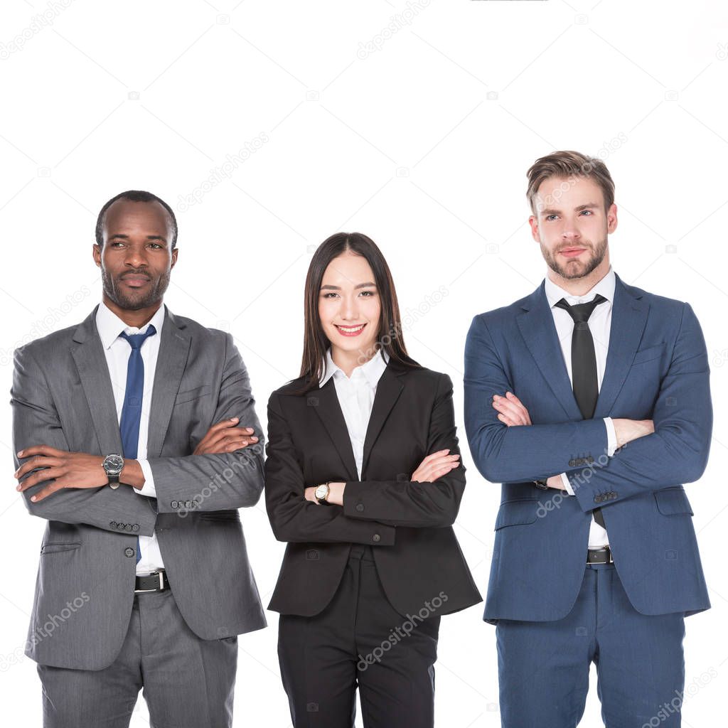 portrait of smiling multicultural young business people with arms crossed isolated on white