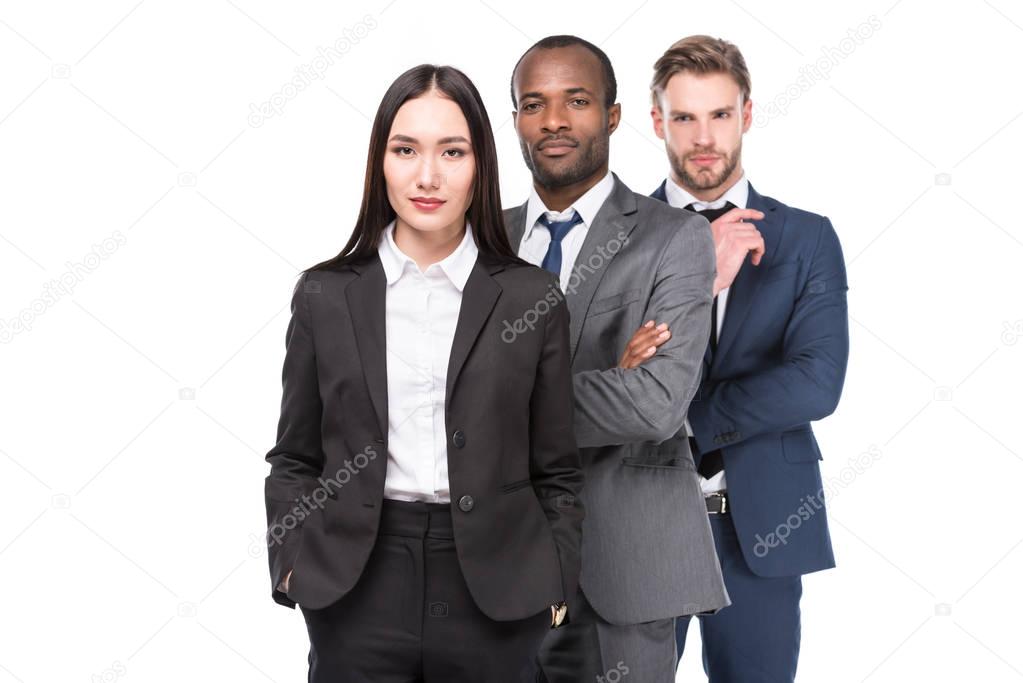 portrait of multicultural young business people in suits isolated on white