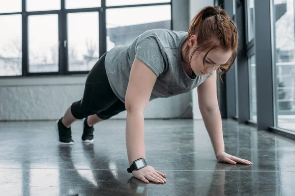 Överviktig Tjej Utför Armhävningar Gymmet — Stockfoto